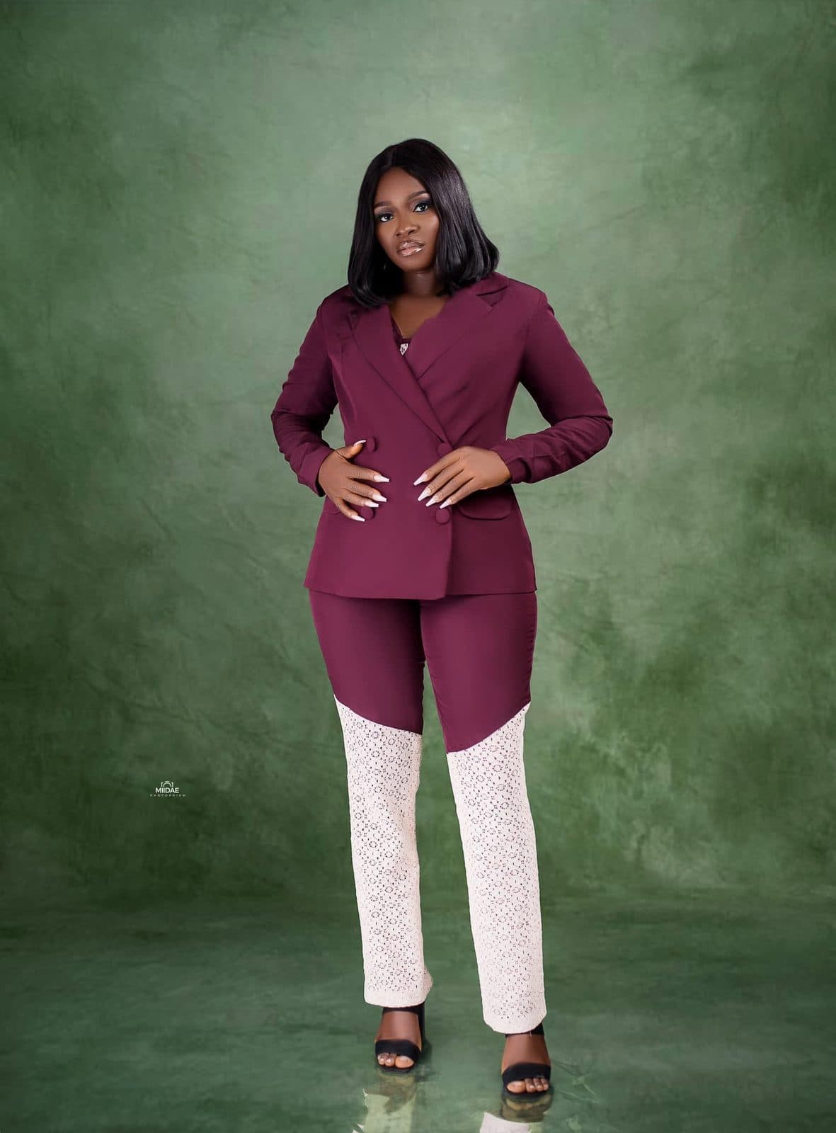 Elizabeth Ori Ikwudiuto in a burgundy suit