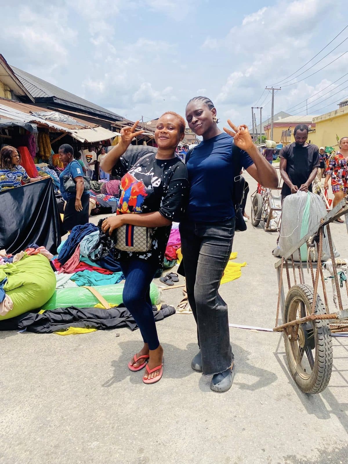 Students shopping for fabric in a market