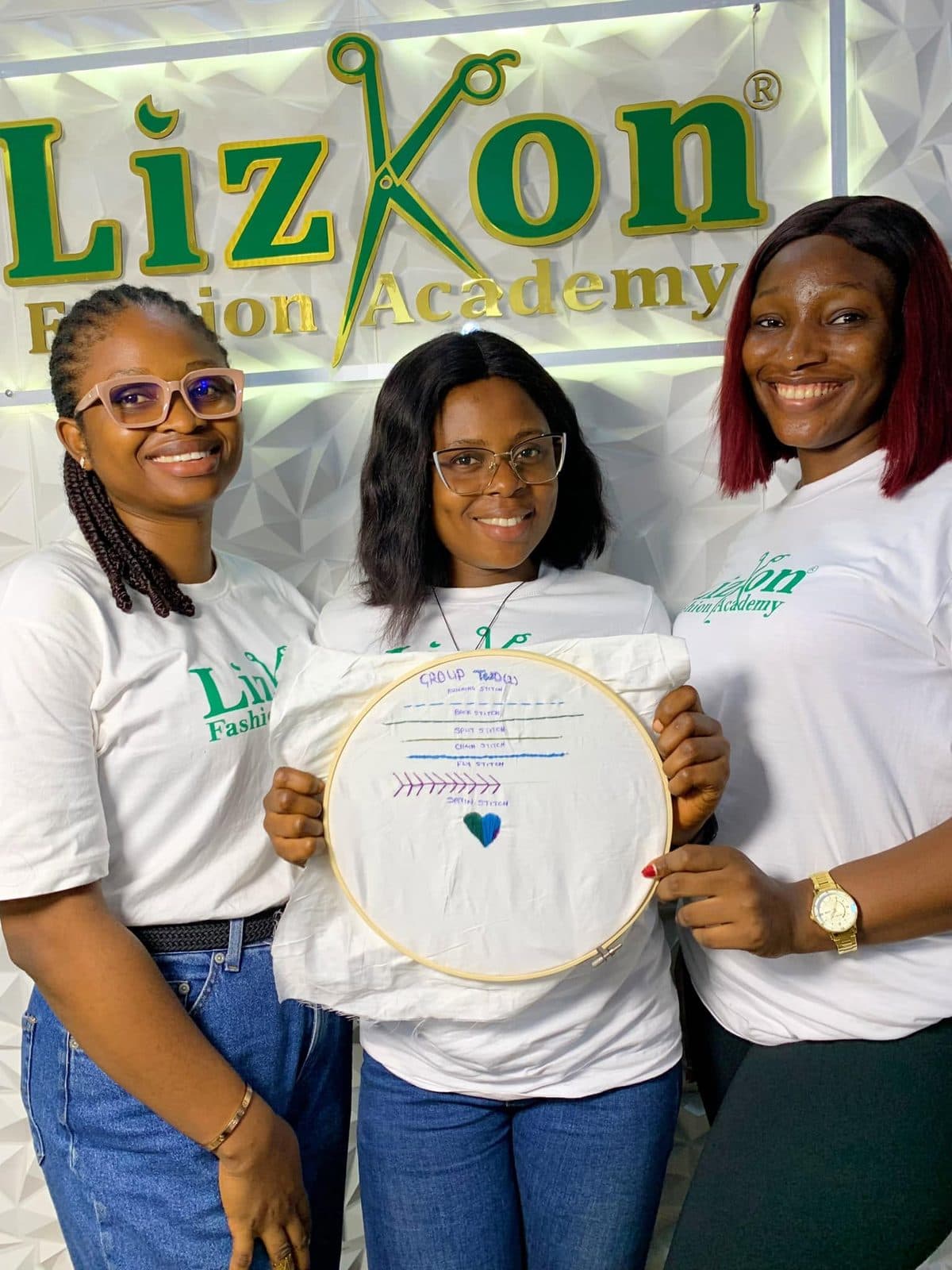 Students holding beading and embroidery hoops