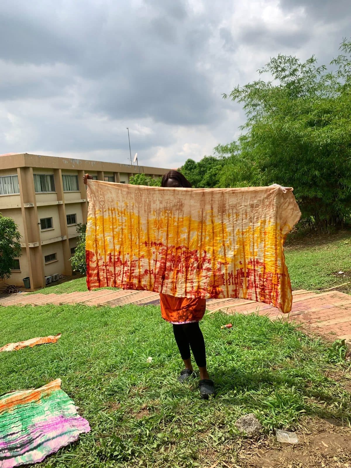 Hand-dyed fabric held up outdoors