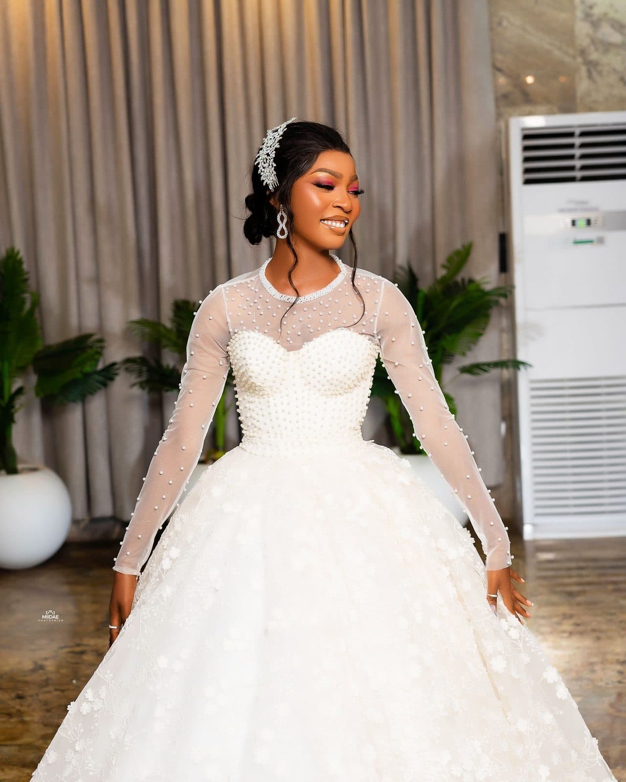 A student's white ball gown with long lace sleeves in a hotel lobby