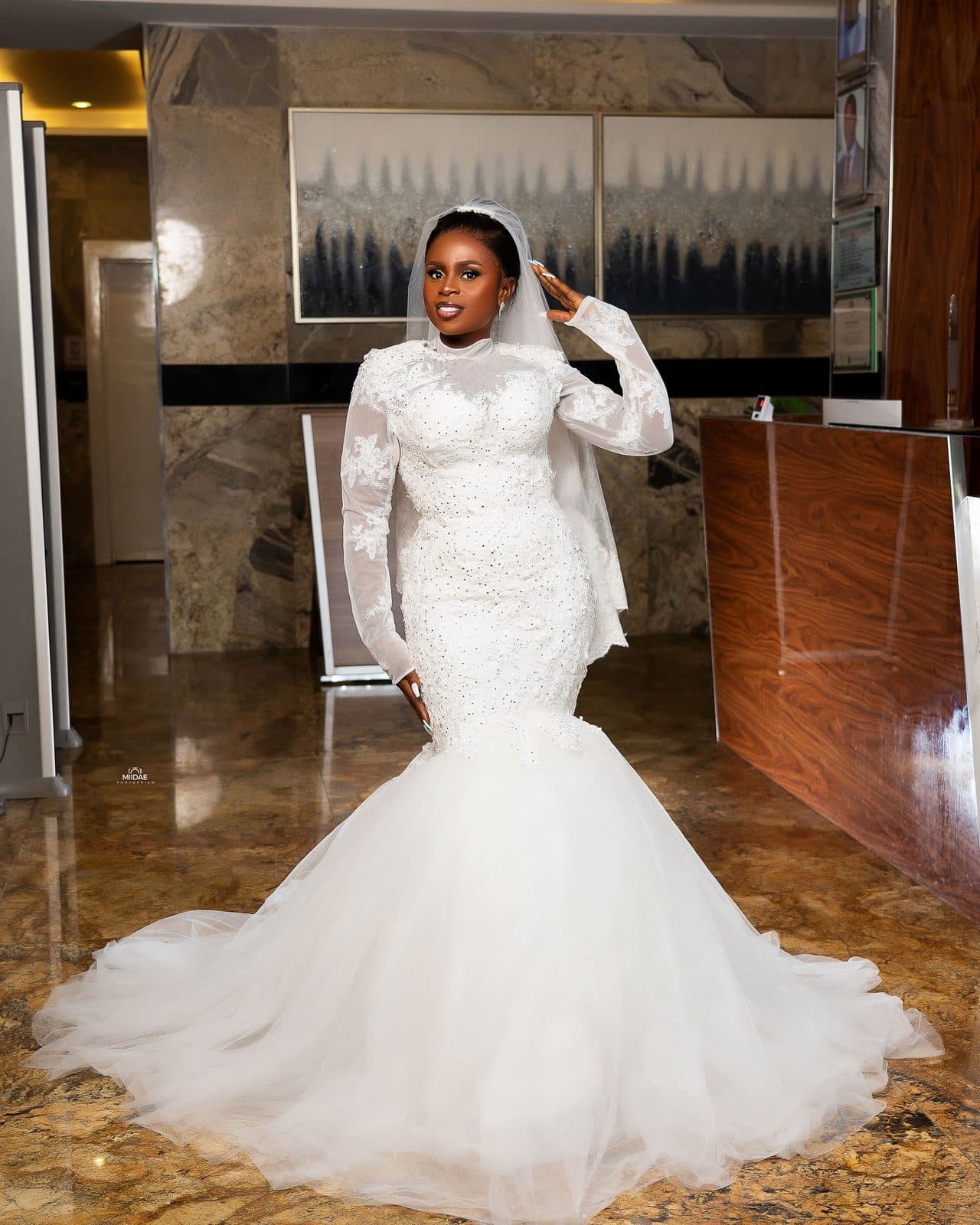 A white tulle mermaid gown in a hotel lobby