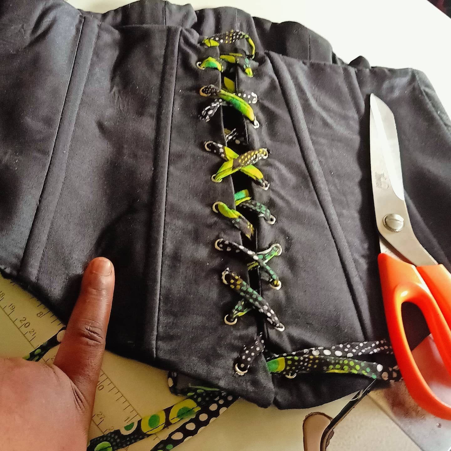 The corset being laced during construction