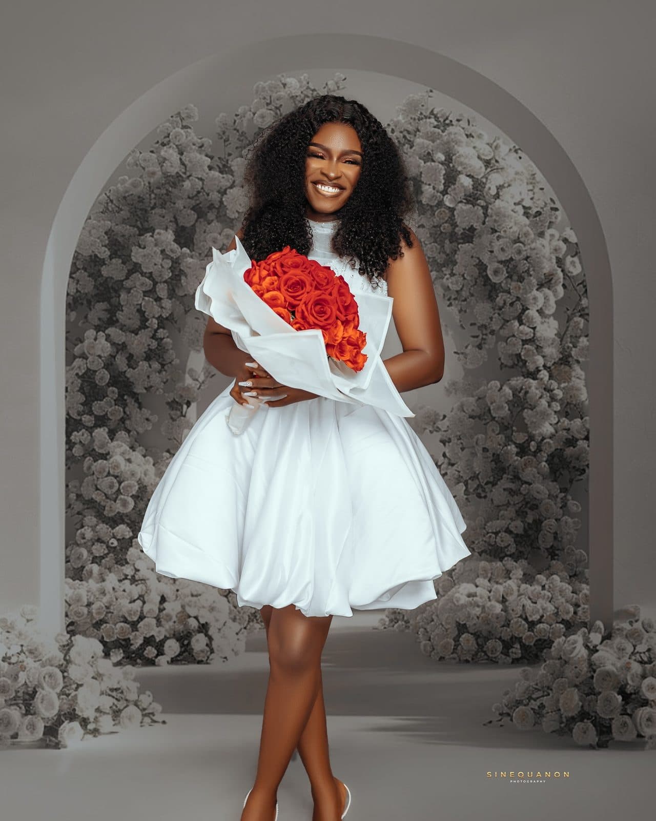 The white mini dress with a bouquet of roses