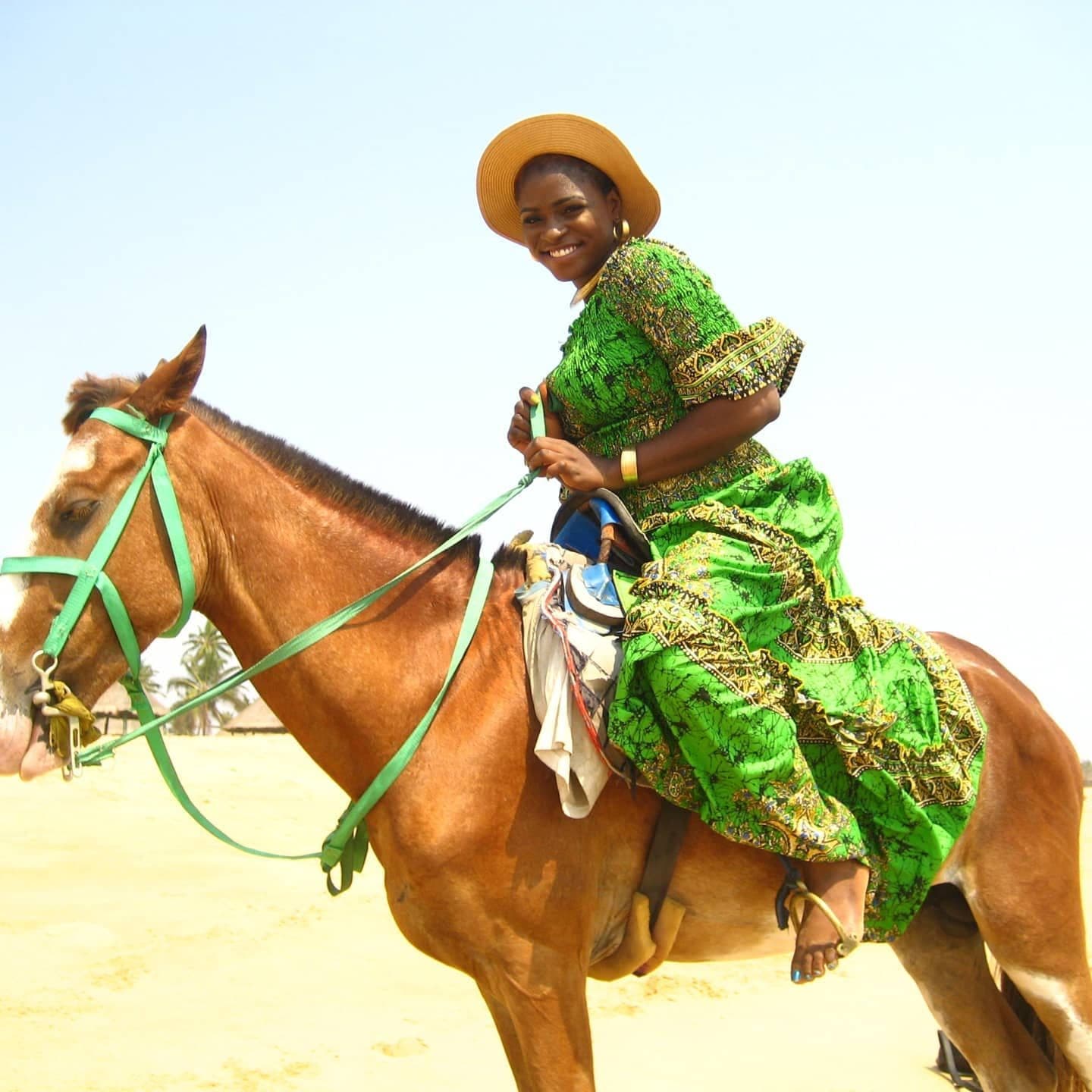 The green Ankara gown photographed on horseback