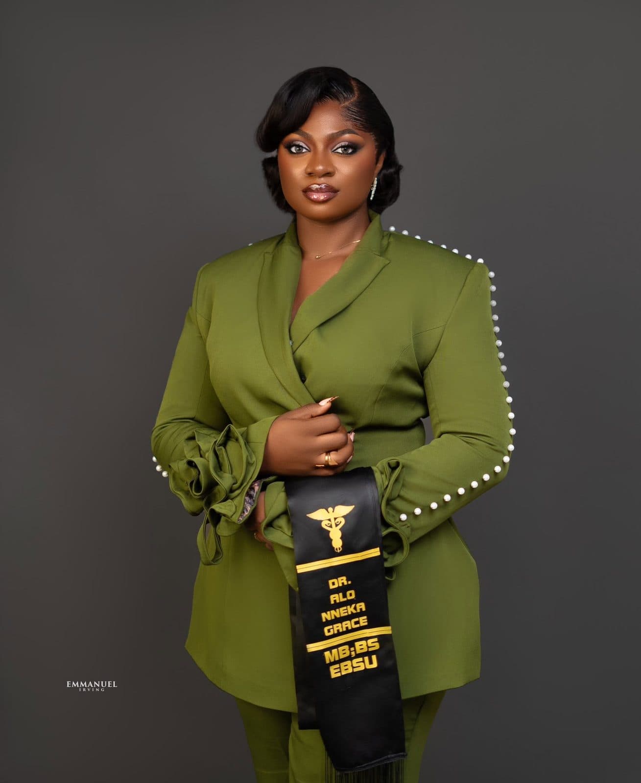 Portrait in the olive blazer with an award sash
