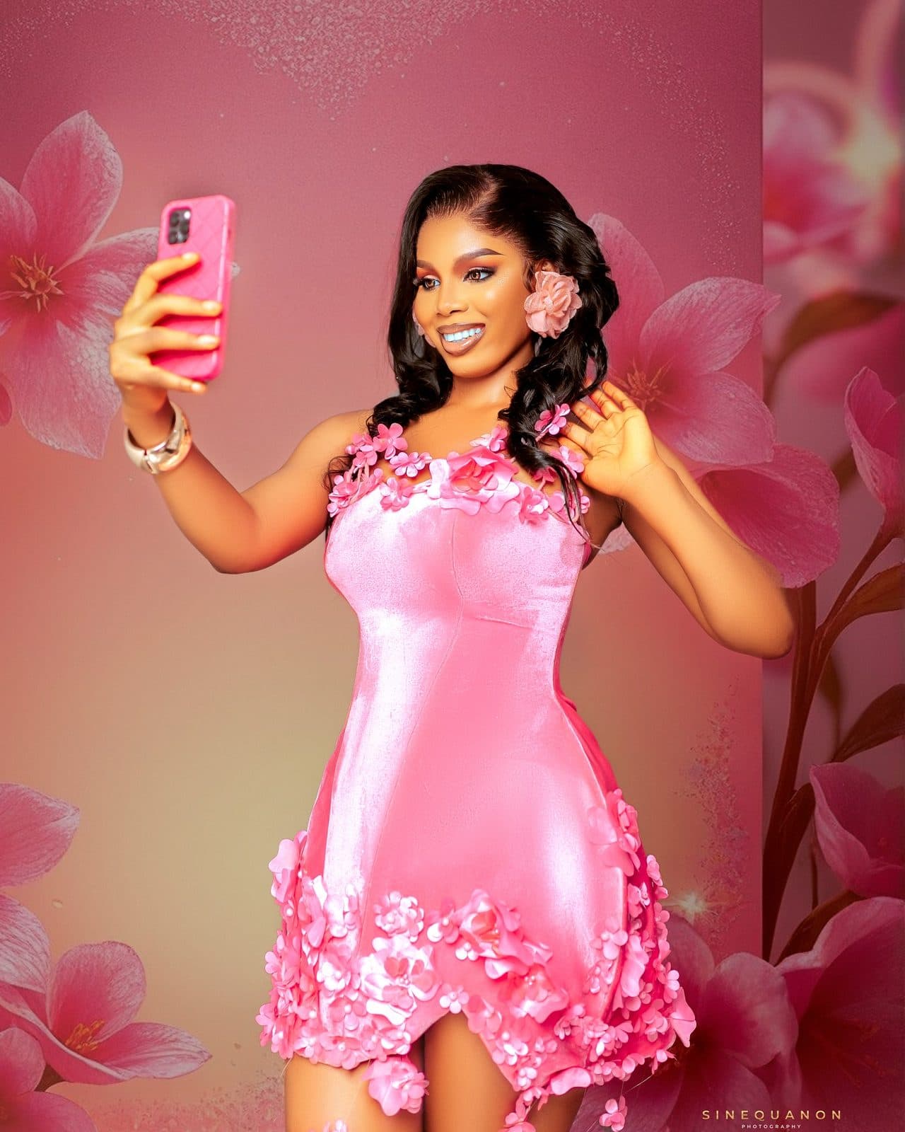 The pink corset mini against a floral backdrop