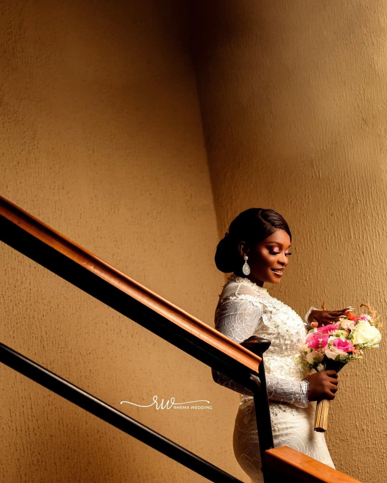 The bride turning on the stairs to show the ruffled skirt