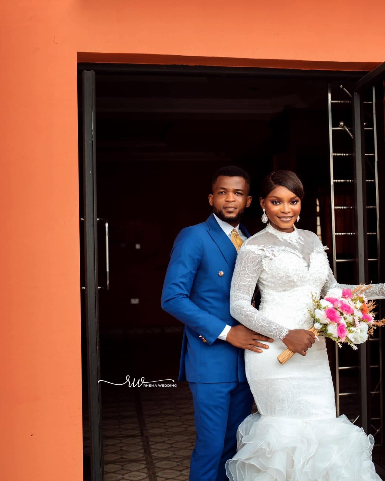 The bride and groom together in a doorway