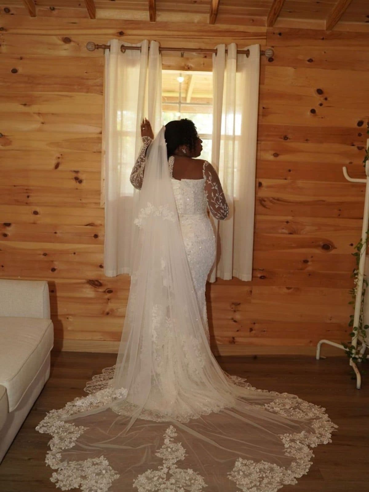 The lace gown photographed in a wooden room before the wedding