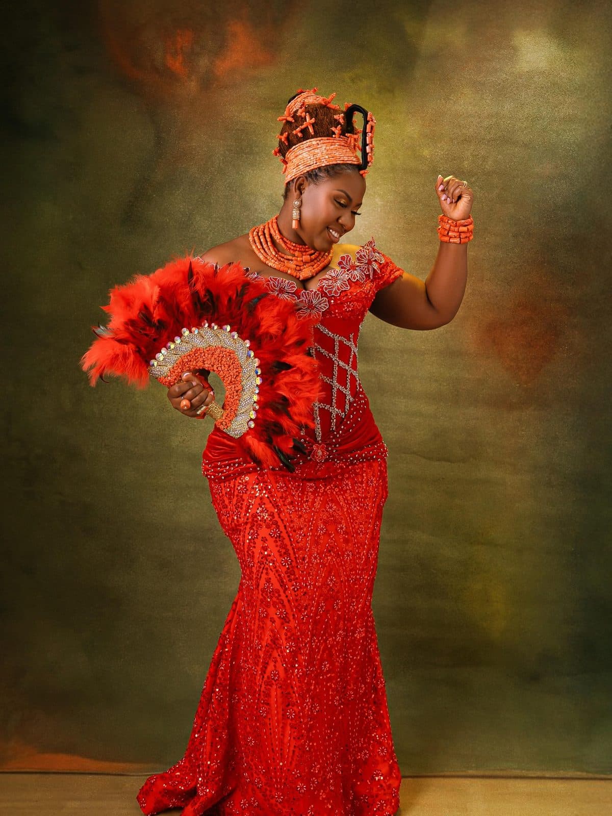 The bride holding a red feather fan