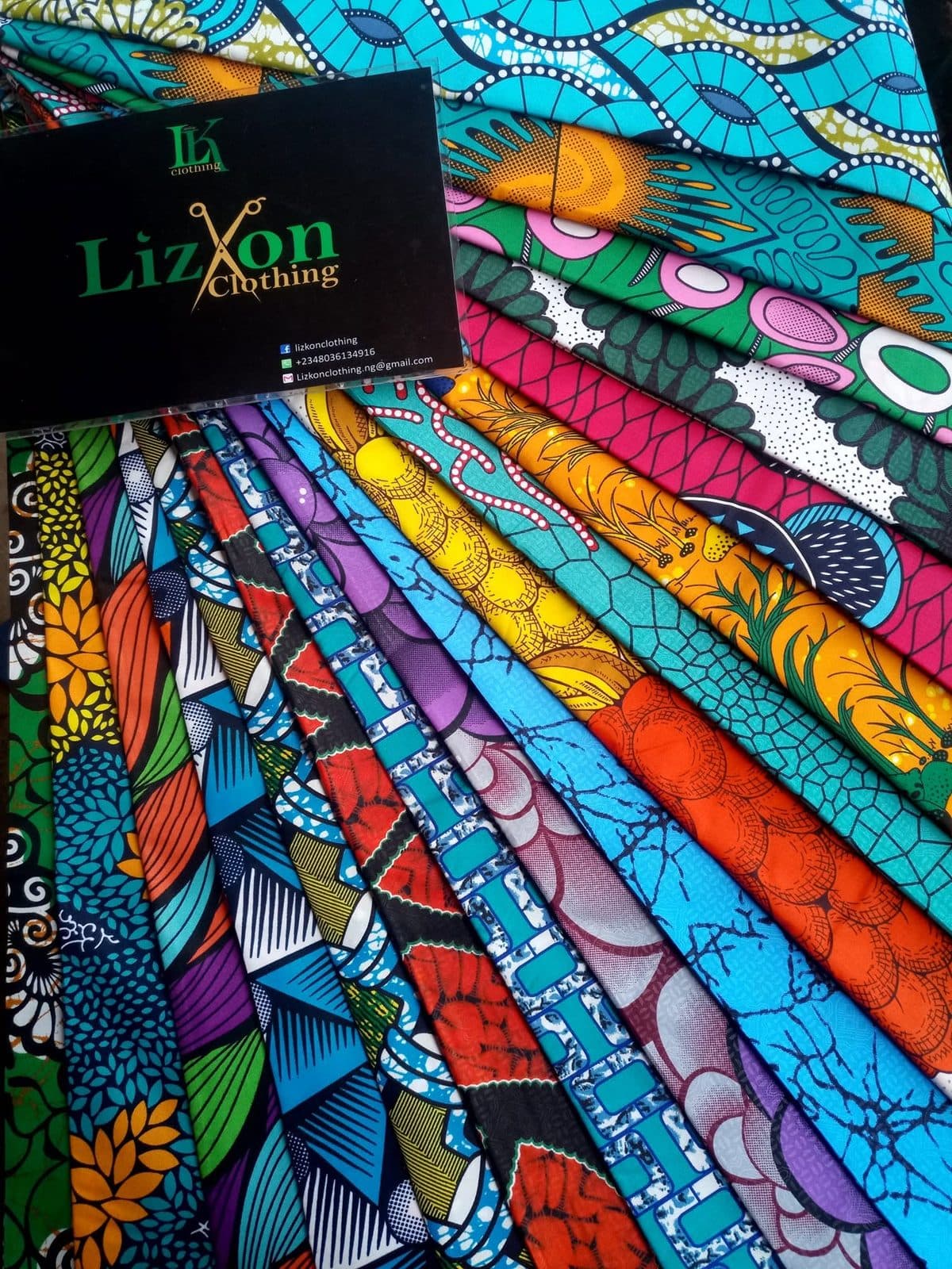 Bundles of Ankara fabric with a Lizkon Fabrics label