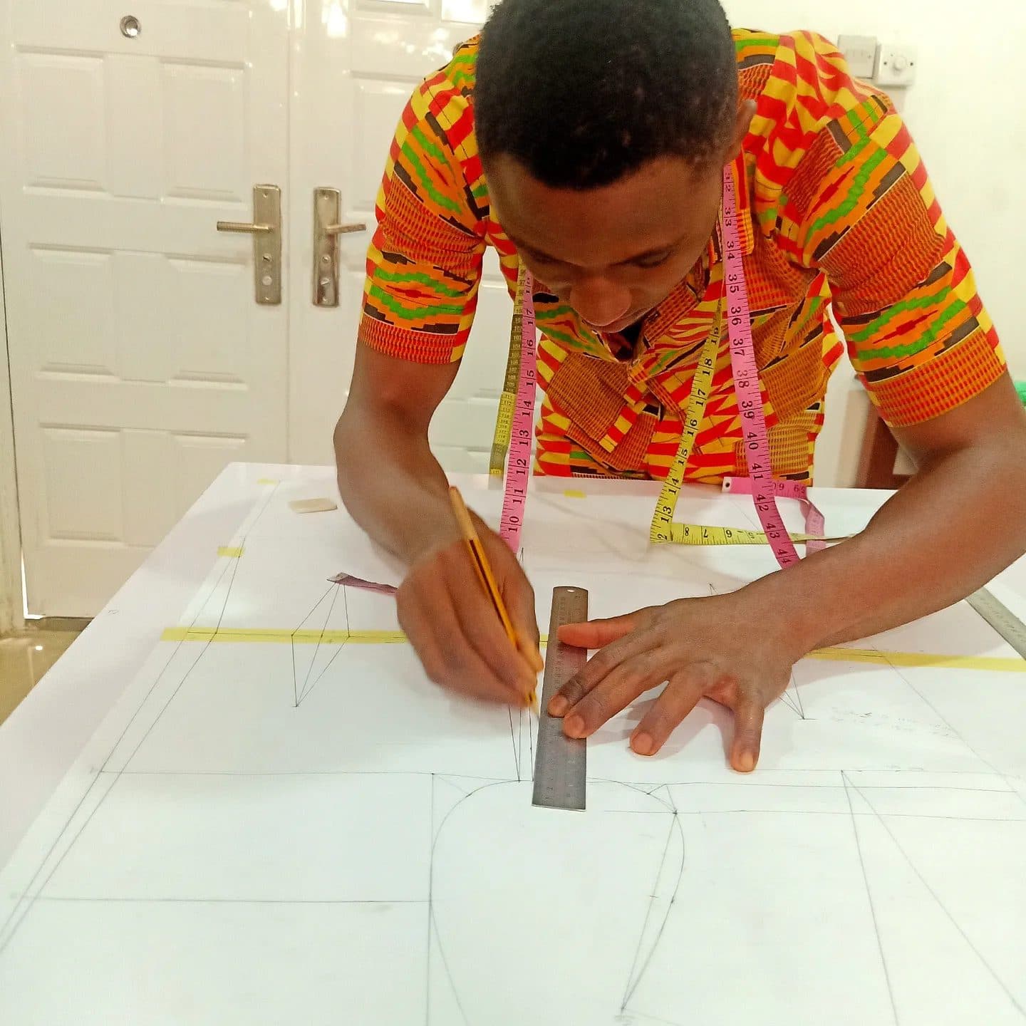 A male student drafting a pattern on his first day