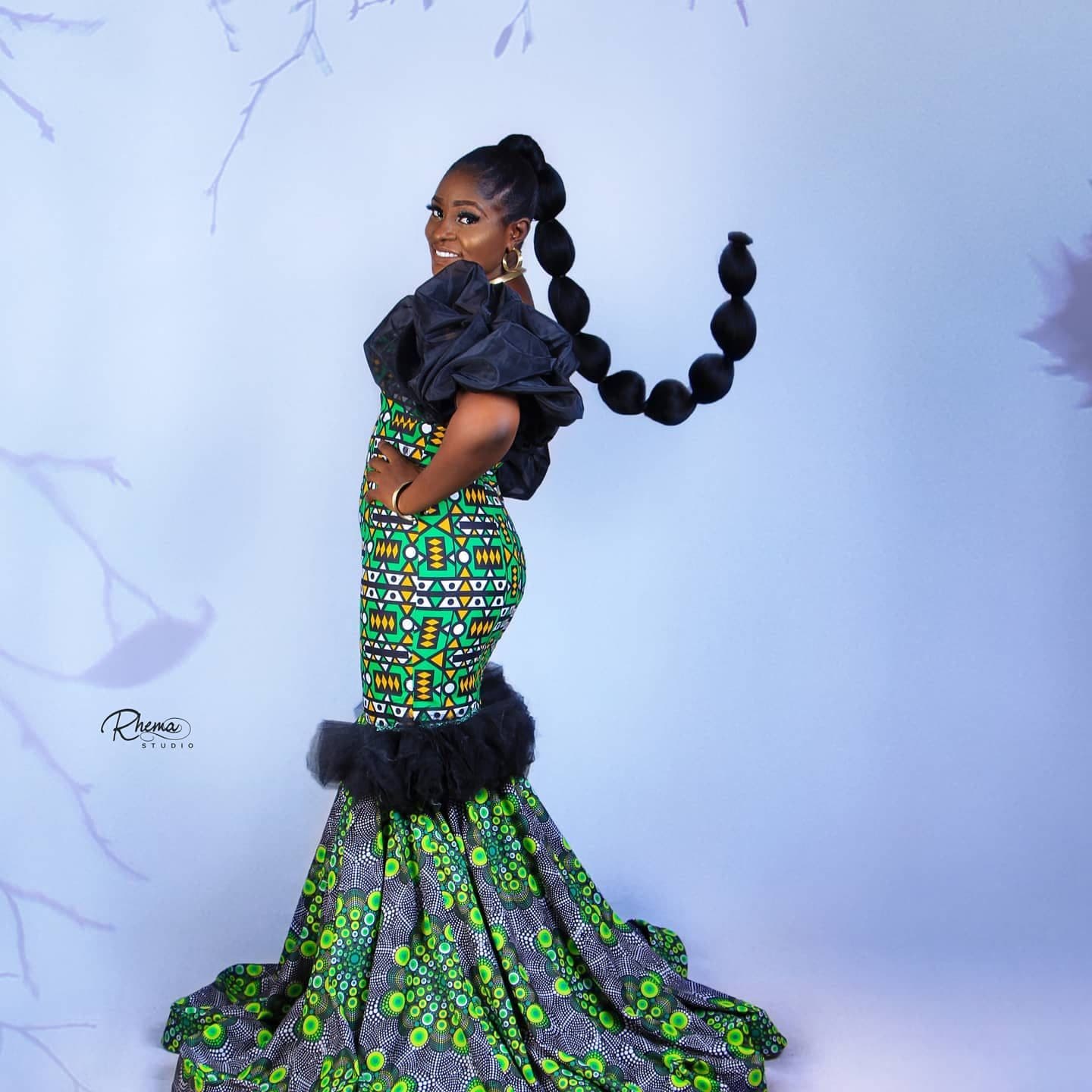 A woman in an Ankara mermaid gown with black ruffles