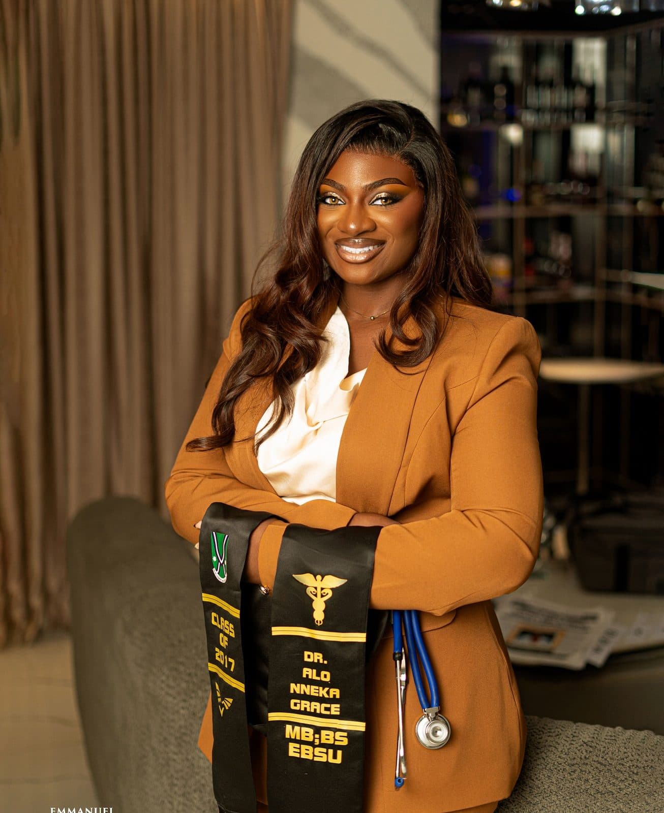 A woman in a tan four-piece blazer set